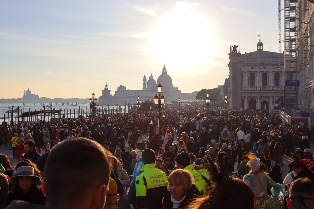 Venice: Everything You Should Know Before Your Trip Crowded Riva degli Schiavoni at sunrise with police and tourists near St Mark’s Basilica in Venice.