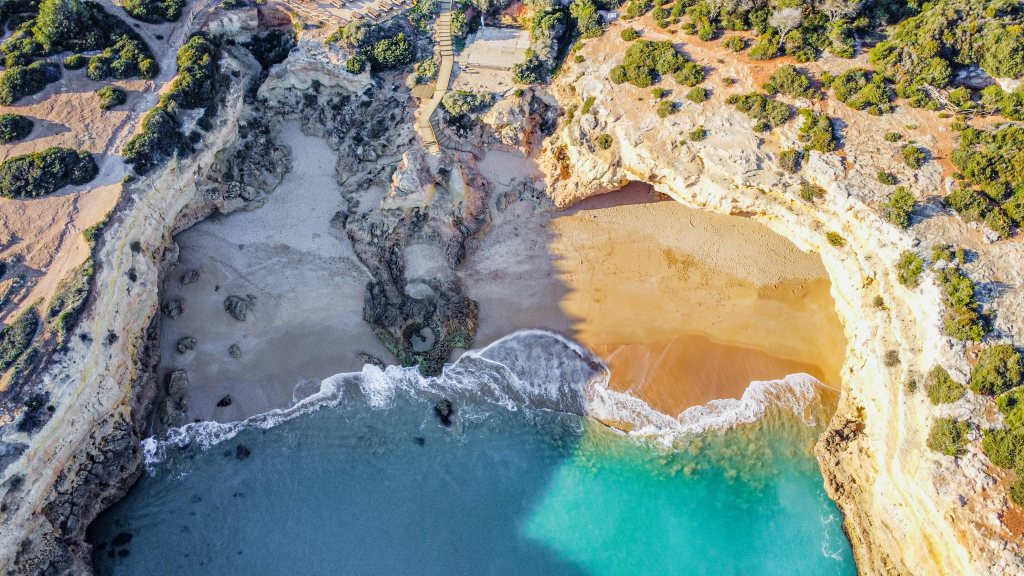 Our Top 7 Beaches in the Algarve Aerial view of Praia de Albandeira with sandy coves, cliffs and turquoise water in the Algarve
