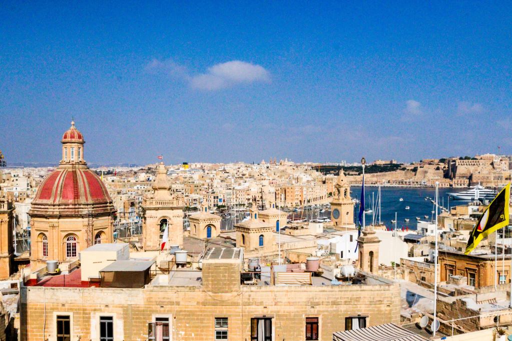 A Guide to Malta’s Three Cities: Discover Birgu, Isla and Bormla Panoramic skyline of Birgu in Malta featuring Baroque church domes and limestone houses.