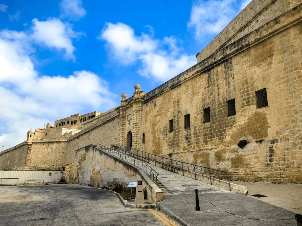 A Guide to Malta’s Three Cities: Discover Birgu, Isla and Bormla Massive limestone defensive walls and a stone ramp leading to the entrance of Fort St Angelo in Birgu.