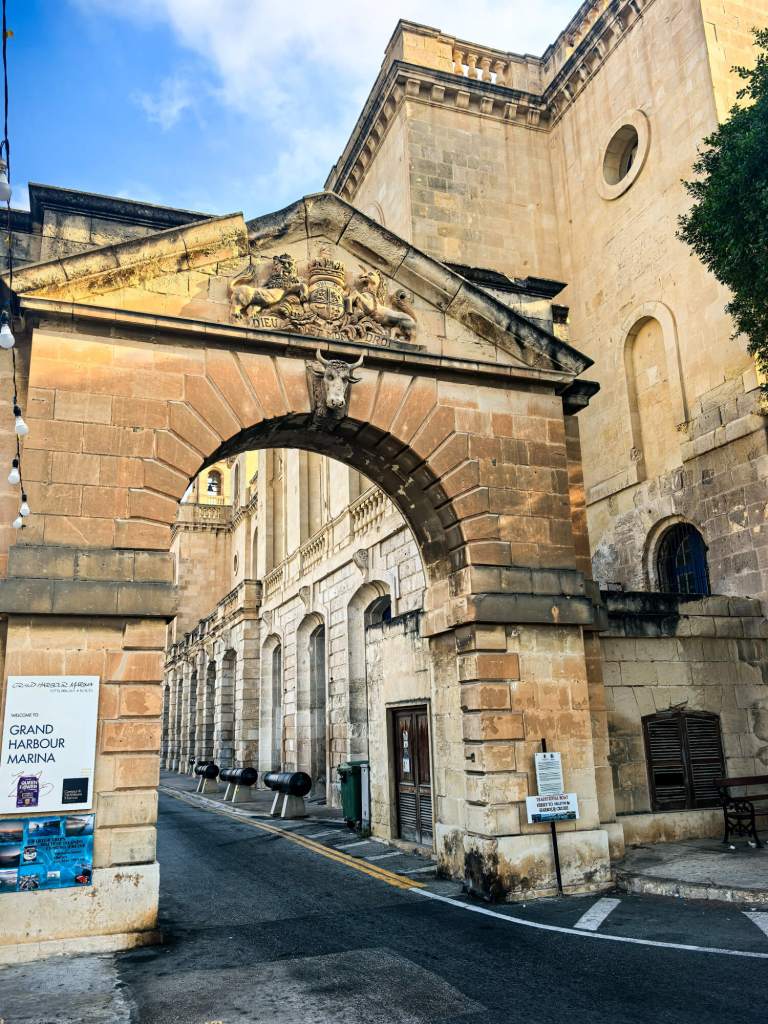 A Guide to Malta’s Three Cities: Discover Birgu, Isla and Bormla A massive stone archway with a sculpted bull's head leading to the Grand Harbour Marina in Vittoriosa.