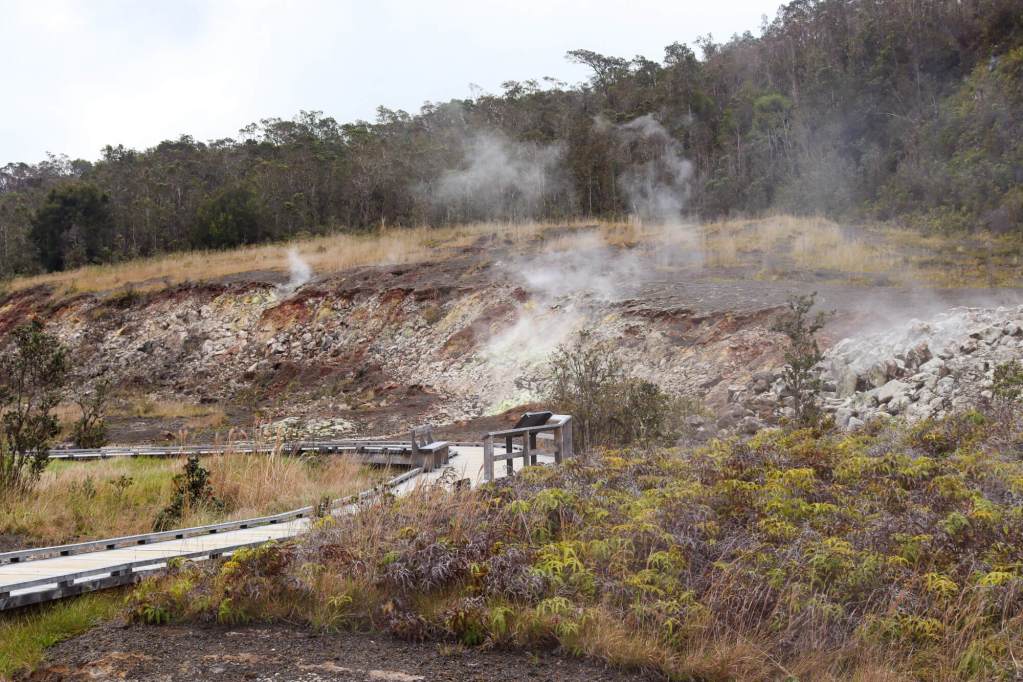Sulphur Banks (Ha‘akulamanu) in Hawaiʻi Volcanoes National Park on the Big Island, featuring rising steam and a wooden walkway.