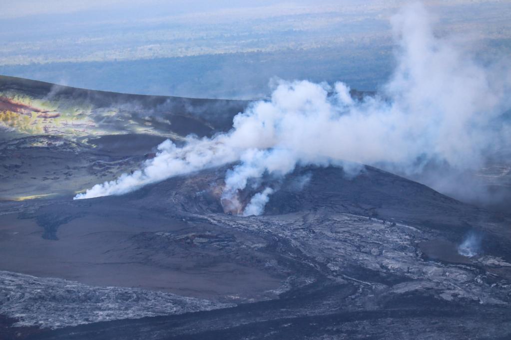 Kīlauea eruptive vents in Hawaiʻi Volcanoes National Park on the Big Island, featuring rising steam and smoke.
